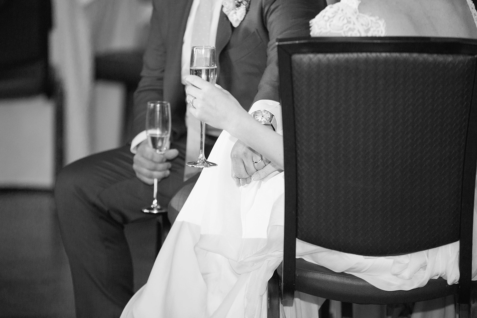 bride & groom holding hands during toasts