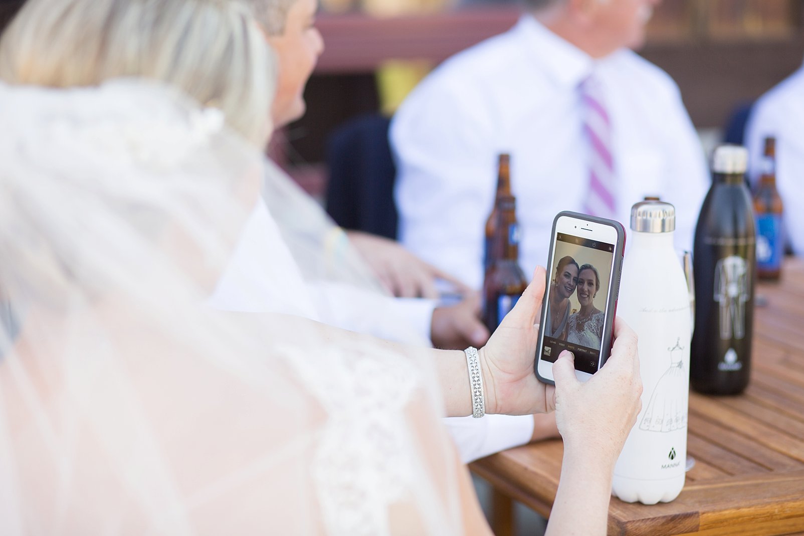 taking a selfie at a wedding with the bride