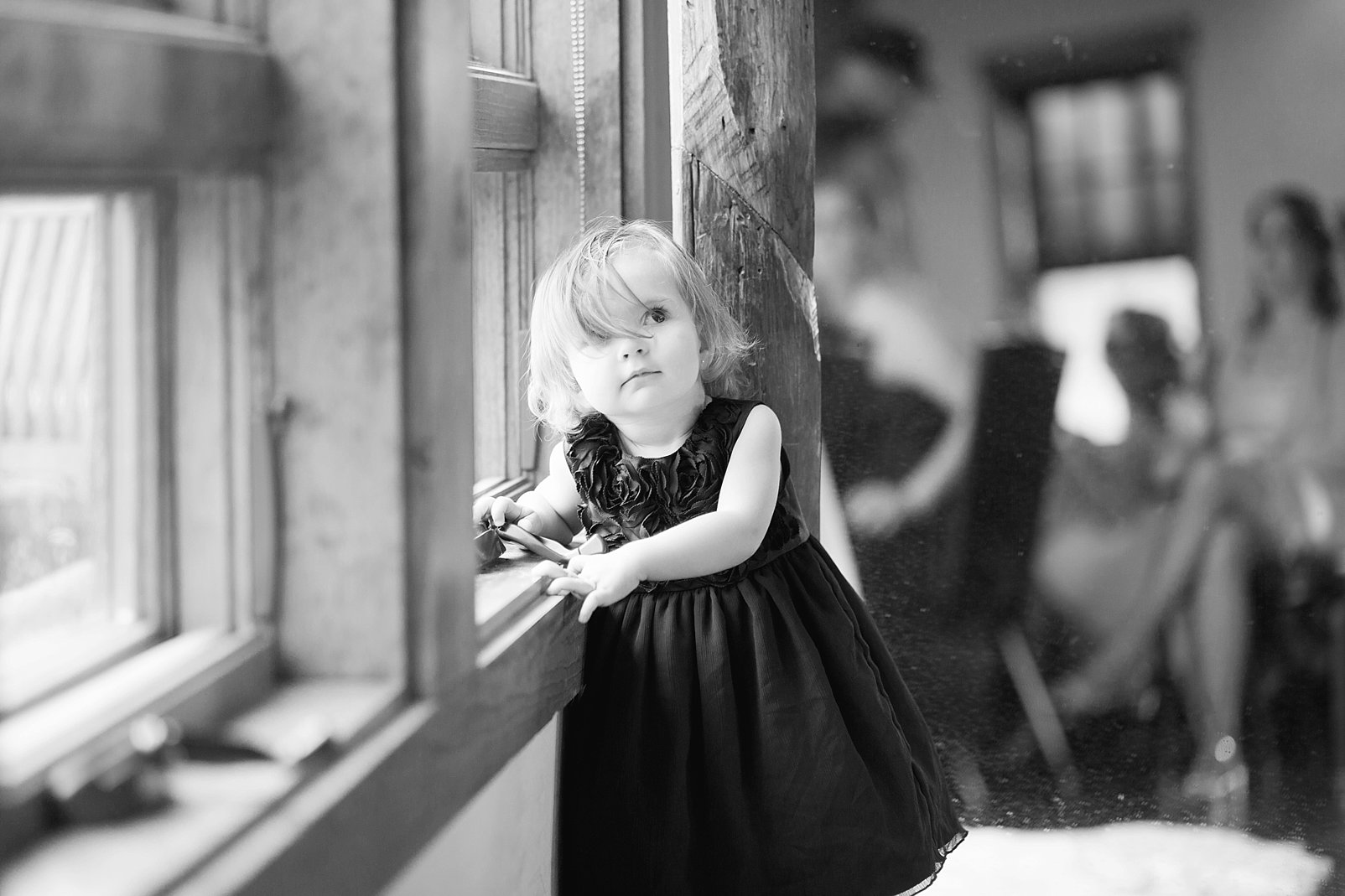 black and white photo of little girl at a wedding