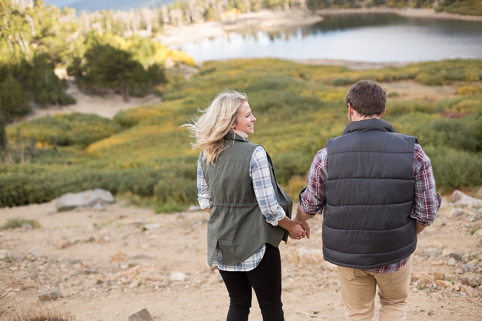 couple hiking down mountain during colorado engagement session