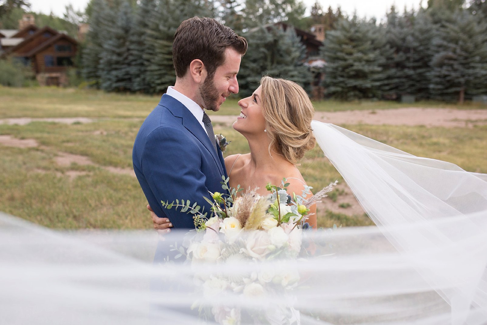 bride and groom photos with veil during vail wedding