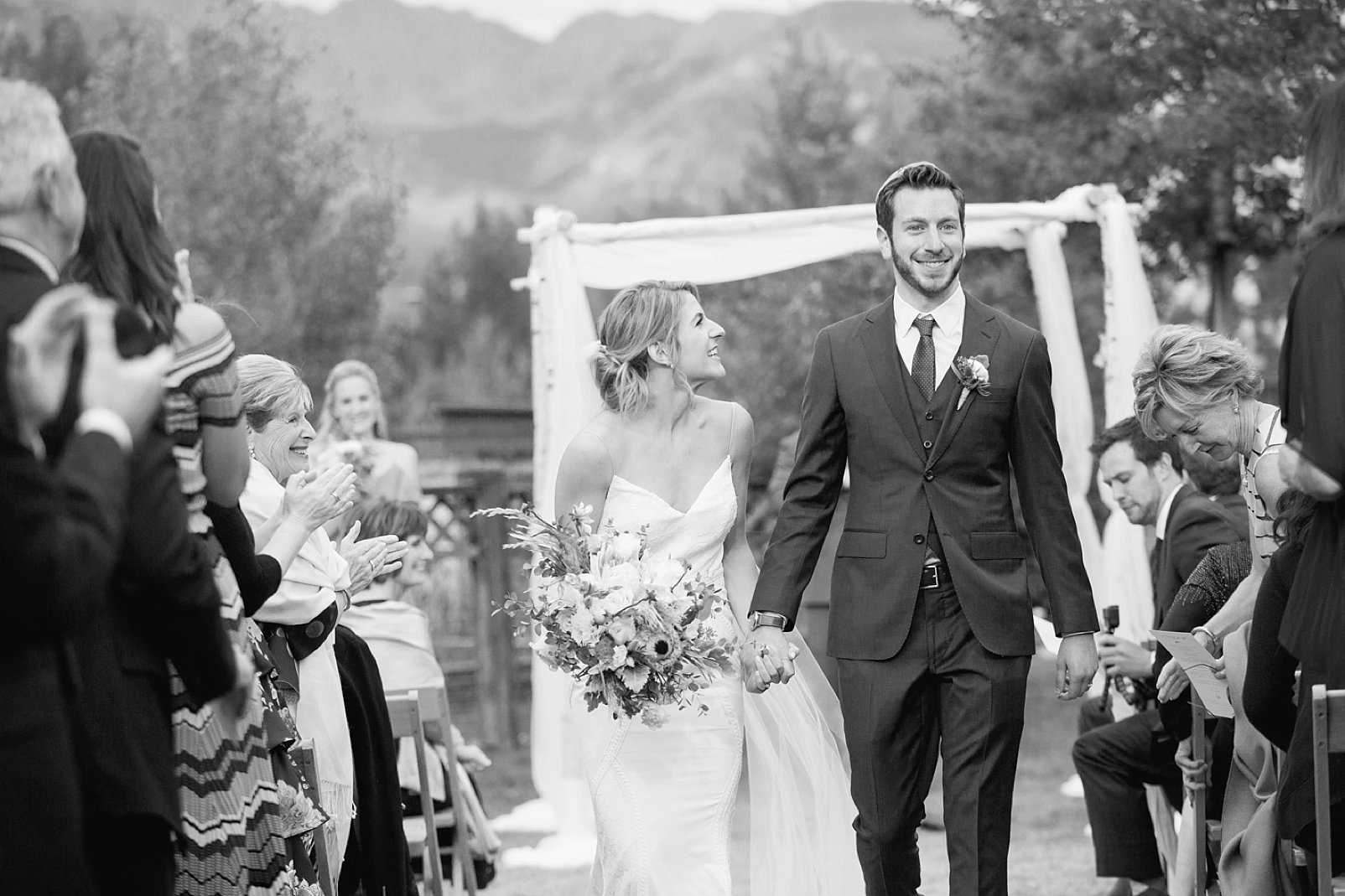 walking down the aisle during larkspur vail wedding photography