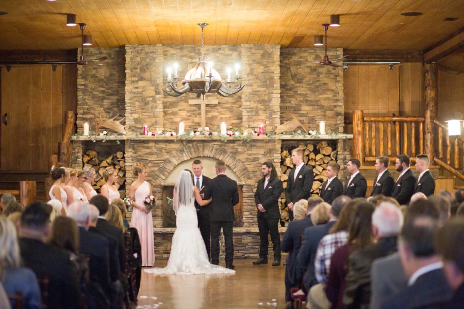 ceremony in alberts lodge during winter colorado wedding at spruce mountain ranch
