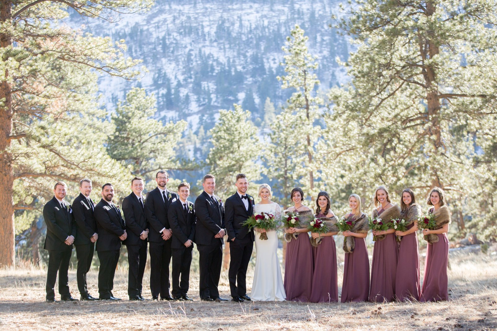 bridal party during outdoor colorado winter wedding in rocky mountain national park