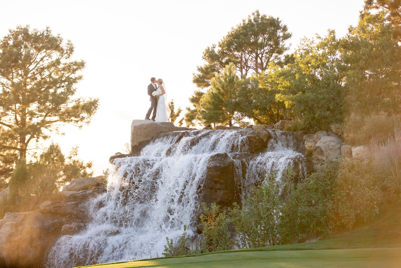 bride and groom photos at waterfall at sanctuary golf course wedding
